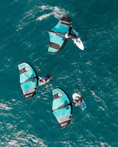 12 месяцев Кайтсерфинг Пуэрто-Рико: исцеление и ветер 6 Три райдера на вингфойле на бирюзовой воде, снятые сверху